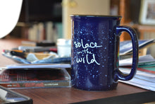 Load image into Gallery viewer, Blue ceramic Solace in the Wild mug on Erin's desk.